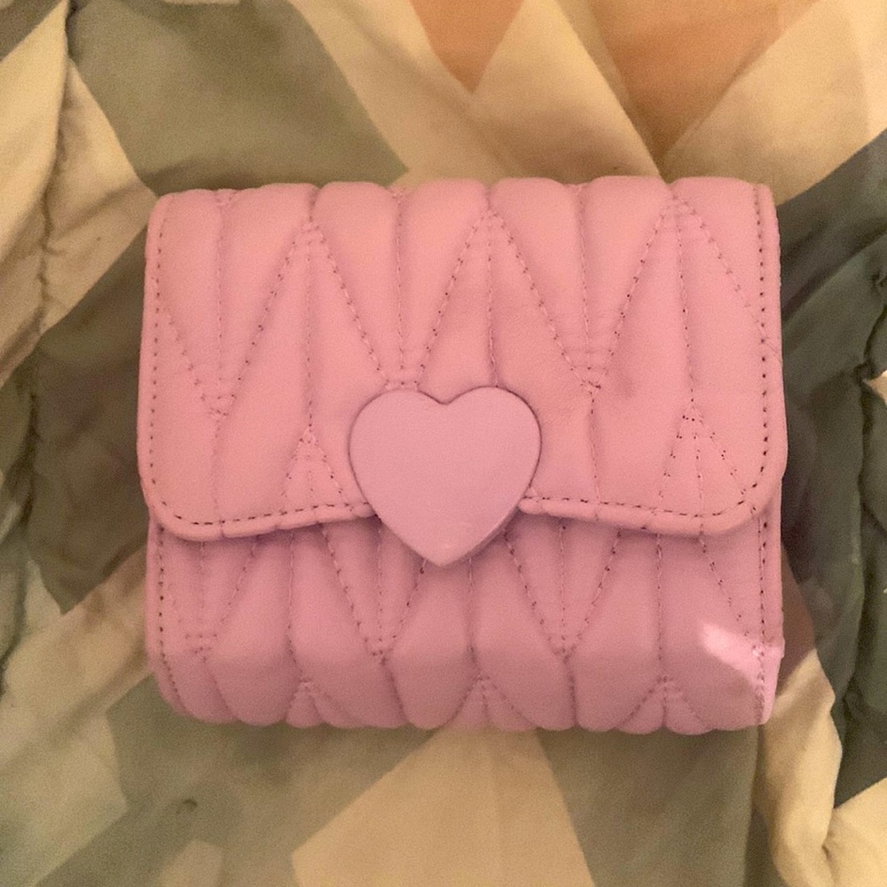 A purple tiny handbag.